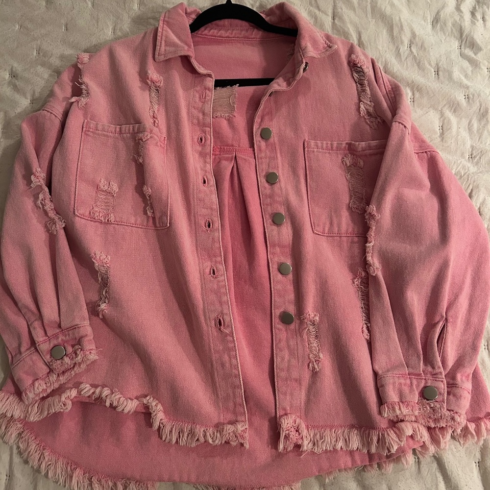 Distressed pink denim jacket